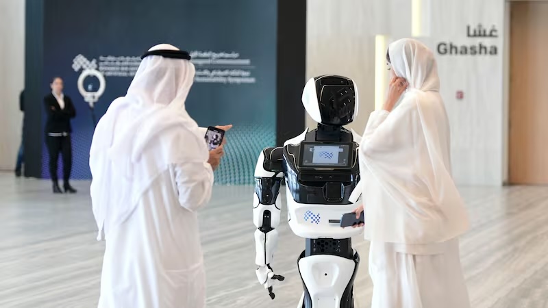 Guests interact with a robot at the Mohamed bin Zayed University of Artificial Intelligence in Abu Dhabi. Khushnum Bhandari / The National