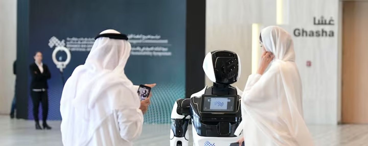 Guests interact with a robot at the Mohamed bin Zayed University of Artificial Intelligence in Abu Dhabi. Khushnum Bhandari / The National