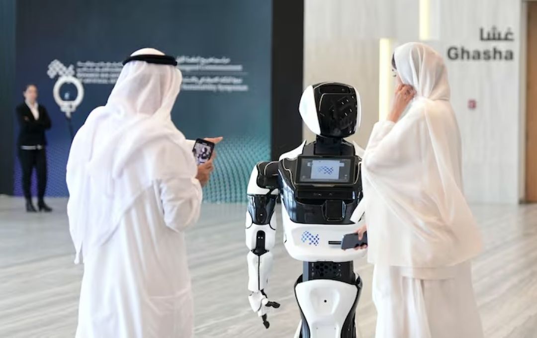 Guests interact with a robot at the Mohamed bin Zayed University of Artificial Intelligence in Abu Dhabi. Khushnum Bhandari / The National